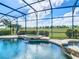 Beautiful in-ground pool and spa area with screened enclosure and serene views of the lush golf course at 8914 Dove Valley Way, Davenport, FL 33896