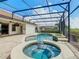 Backyard pool and spa area with covered patio and view of screened-in pool with golf course at 8914 Dove Valley Way, Davenport, FL 33896