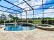 Enclosed pool and spa area with an outdoor seating area and a view of the luscious golf course at 8914 Dove Valley Way, Davenport, FL 33896