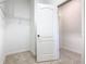 A walk-in closet with white walls, beige carpet, and wire shelving ready for organization at 8914 Dove Valley Way, Davenport, FL 33896