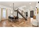 Elegant dining room featuring herringbone wood floors and modern staircase with views of the entry at 1606 Hart Ln, Orlando, FL 32804