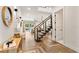Bright foyer with modern staircase, herringbone wood floors, and views to the living area and outdoor pool at 1606 Hart Ln, Orlando, FL 32804