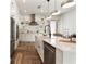 Bright kitchen with white cabinetry, stainless steel appliances, and sleek countertops at 1606 Hart Ln, Orlando, FL 32804