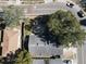 Aerial view of gray house with dark roof surrounded by trees and a corner lot at 2212 Atrium Cir, Orlando, FL 32808
