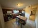 A compact kitchen features wood cabinets, stainless steel appliances, and an island with seating at 2212 Atrium Cir, Orlando, FL 32808
