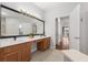 Bright bathroom features dual sinks, a vanity area, and access to the hallway and shower room at 698 Mt Pleasant Dr, Ocoee, FL 34761