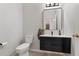 Modern powder room features a black vanity with a white countertop and a stylish mirror at 698 Mt Pleasant Dr, Ocoee, FL 34761