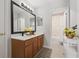 Bright bathroom featuring a double sink vanity, decorative accents and tiled floors at 698 Mt Pleasant Dr, Ocoee, FL 34761