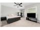 Bedroom with a queen-size bed, a workspace, and a large TV at 698 Mt Pleasant Dr, Ocoee, FL 34761