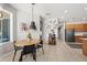 Cozy dining area featuring a wooden table, black chairs, and decorative accents against a neutral backdrop at 698 Mt Pleasant Dr, Ocoee, FL 34761