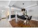 Spacious dining room with hardwood floors and modern light fixture at 698 Mt Pleasant Dr, Ocoee, FL 34761