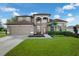 Charming two-story home with a manicured lawn and elegant front entrance, including a fountain at 698 Mt Pleasant Dr, Ocoee, FL 34761