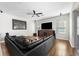 Gathering room with a large sectional sofa and wood flooring at 698 Mt Pleasant Dr, Ocoee, FL 34761