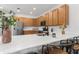 Contemporary kitchen with wooden cabinets, stainless steel appliances, quartz countertops and island seating at 698 Mt Pleasant Dr, Ocoee, FL 34761