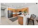 Modern kitchen with stainless steel appliances, wooden cabinets and a large island with bar seating at 698 Mt Pleasant Dr, Ocoee, FL 34761