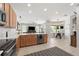 Bright kitchen with wood cabinets, stainless steel appliances, an eat-in island, and access to the dining area at 698 Mt Pleasant Dr, Ocoee, FL 34761