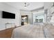 Bright main bedroom featuring a king-size bed and access to the backyard at 698 Mt Pleasant Dr, Ocoee, FL 34761