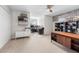 Home office with large desk, shelving, and a view to a secondary workspace at 698 Mt Pleasant Dr, Ocoee, FL 34761