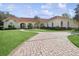 Luxury home with red tile roof, lush lawn, and circular driveway at 1000 Dunhurst Ct, Longwood, FL 32779