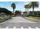 Gated community entrance with palm trees and landscaping at 1720 Garden Sage Dr, Oviedo, FL 32765