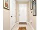 Bright entryway with tile flooring, coat closet, and welcoming mat at 1720 Garden Sage Dr, Oviedo, FL 32765