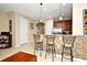 Kitchen with breakfast bar, stainless steel appliances, and tile flooring at 1720 Garden Sage Dr, Oviedo, FL 32765