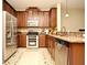 Modern kitchen with stainless steel appliances and wood cabinets at 1720 Garden Sage Dr, Oviedo, FL 32765