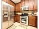 Stainless steel appliances and wood cabinets in this updated kitchen at 1720 Garden Sage Dr, Oviedo, FL 32765