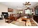 Spacious living room with leather sectional sofa and ceiling fan at 1720 Garden Sage Dr, Oviedo, FL 32765