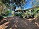 Spacious backyard featuring lush landscaping, mature trees, and a private perimeter at 403 Tranquille Oaks Dr, Ocoee, FL 34761