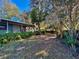 Backyard exterior view showcasing lush landscaping, mature trees, and serene outdoor living at 403 Tranquille Oaks Dr, Ocoee, FL 34761