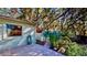 View of the backyard featuring a shed, patio, and lush landscaping with mature trees at 403 Tranquille Oaks Dr, Ocoee, FL 34761