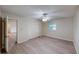 Bright bedroom features neutral walls, ceiling fan, and a closet with bi-fold doors at 403 Tranquille Oaks Dr, Ocoee, FL 34761