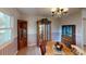 Dining room boasts wood furniture, chandelier, and decorative china cabinets at 403 Tranquille Oaks Dr, Ocoee, FL 34761