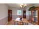 Traditional dining room featuring wood table, chandelier, and vintage corner cabinets at 403 Tranquille Oaks Dr, Ocoee, FL 34761
