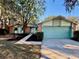 Charming single-story home with manicured front yard, brick accents, and a two-car garage at 403 Tranquille Oaks Dr, Ocoee, FL 34761