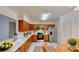 Efficient kitchen with wood cabinetry, stainless steel appliances, and a breakfast area at 403 Tranquille Oaks Dr, Ocoee, FL 34761
