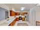 The kitchen features wooden cabinets, stainless steel appliances, and a window view at 403 Tranquille Oaks Dr, Ocoee, FL 34761