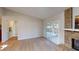 Spacious living room with a brick fireplace and sliding glass doors to the screened porch at 403 Tranquille Oaks Dr, Ocoee, FL 34761