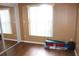 Bedroom with hardwood floors, window with blinds, and closet with mirrored doors at 4925 Cedarstone Ln, Orlando, FL 32822