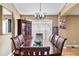 Formal dining room with wood table, cabinet, and sliding glass door allowing natural light at 4925 Cedarstone Ln, Orlando, FL 32822