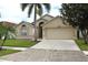 Charming single Gathering house featuring a two-car garage and landscaped front yard at 4925 Cedarstone Ln, Orlando, FL 32822