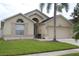 Well-maintained home with two-car garage and landscaped front yard at 4925 Cedarstone Ln, Orlando, FL 32822