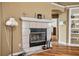 Living room fireplace with tile surround and mantel, complemented by hardwood floors and neutral wall color at 4925 Cedarstone Ln, Orlando, FL 32822