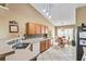 Cozy kitchen with wood cabinets, tiled backsplash, and an adjacent dining area with natural light at 4925 Cedarstone Ln, Orlando, FL 32822
