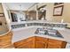 Open kitchen featuring a double sink, tile backsplash and views to the dining and Gathering rooms at 4925 Cedarstone Ln, Orlando, FL 32822