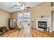 Living room featuring hardwood floors, a fireplace, and sliding doors to the sunroom at 4925 Cedarstone Ln, Orlando, FL 32822