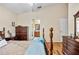 Main bedroom with ensuite bathroom and wooden furniture at 4925 Cedarstone Ln, Orlando, FL 32822