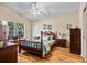 Primary bedroom boasts wood floors, a ceiling fan, and a spacious layout with a large window at 4925 Cedarstone Ln, Orlando, FL 32822