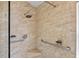 Walk-in shower with accessible grab bars, tiled walls, and updated fixtures at 4925 Cedarstone Ln, Orlando, FL 32822